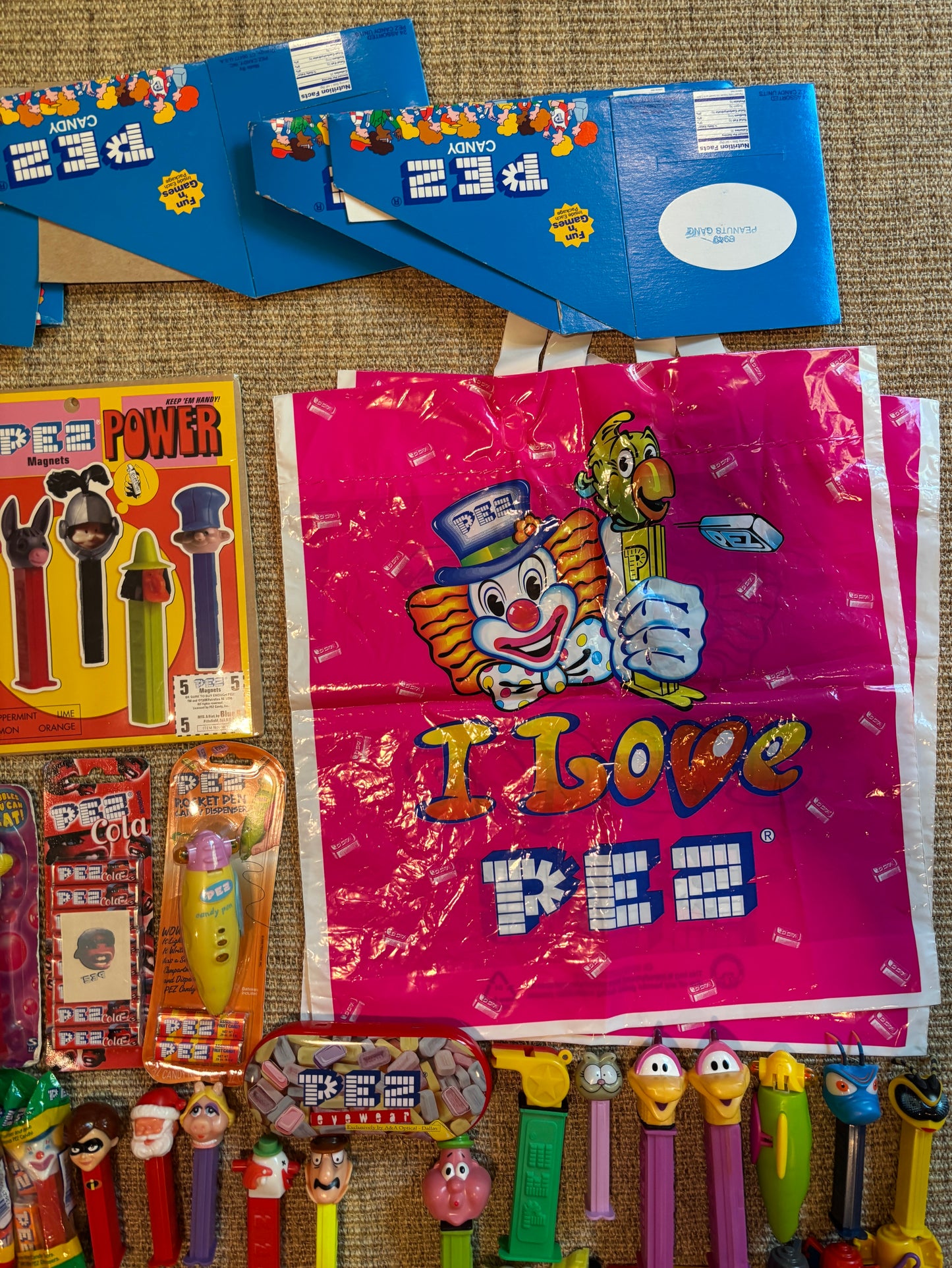 Collection of Pez dispensers and packaging on a textured surface