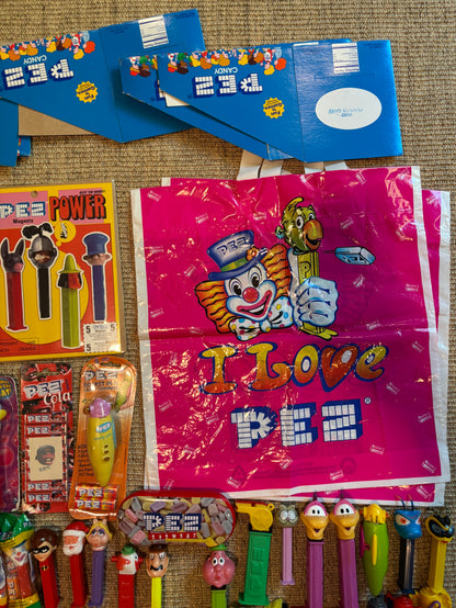 Collection of Pez dispensers and packaging on a textured surface