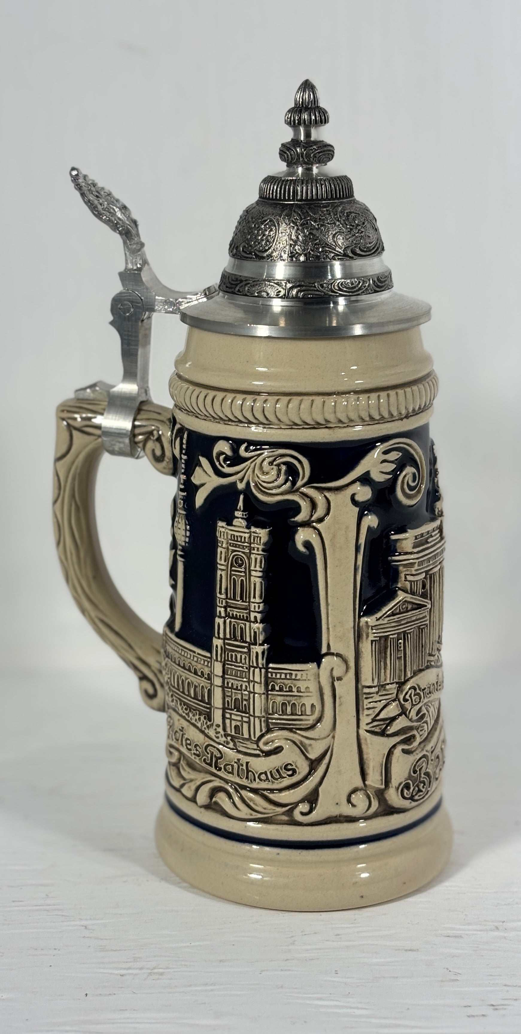 Decorative beer stein with intricate design on a white background