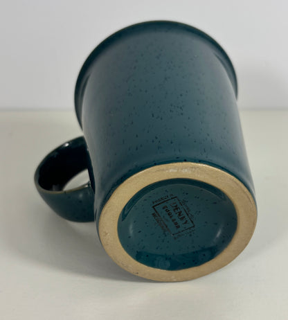 Blue ceramic mug with speckled texture on a white background