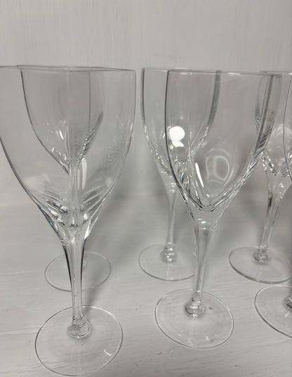 Set of clear wine glasses on a light gray surface