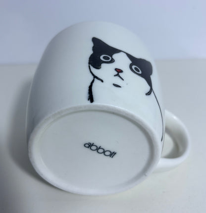 White mug with a black and white cat illustration on a white background