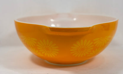 Orange bowl with yellow floral patterns on a white background