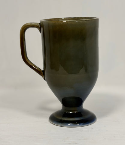 Dark green ceramic mug on a light gray background