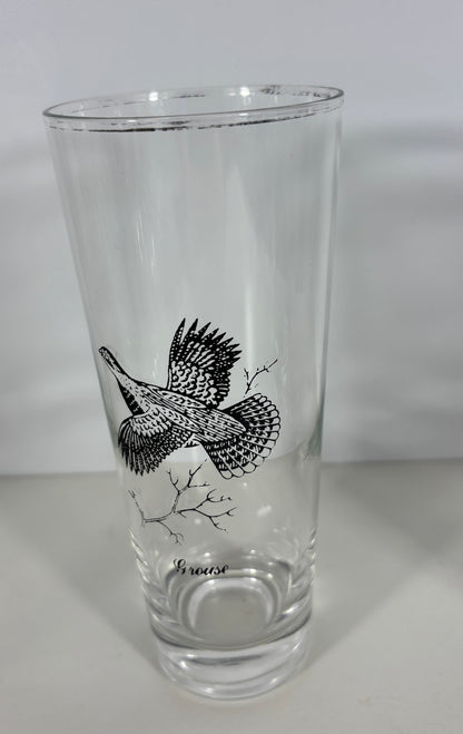 Clear glass with a black bird illustration on a white background