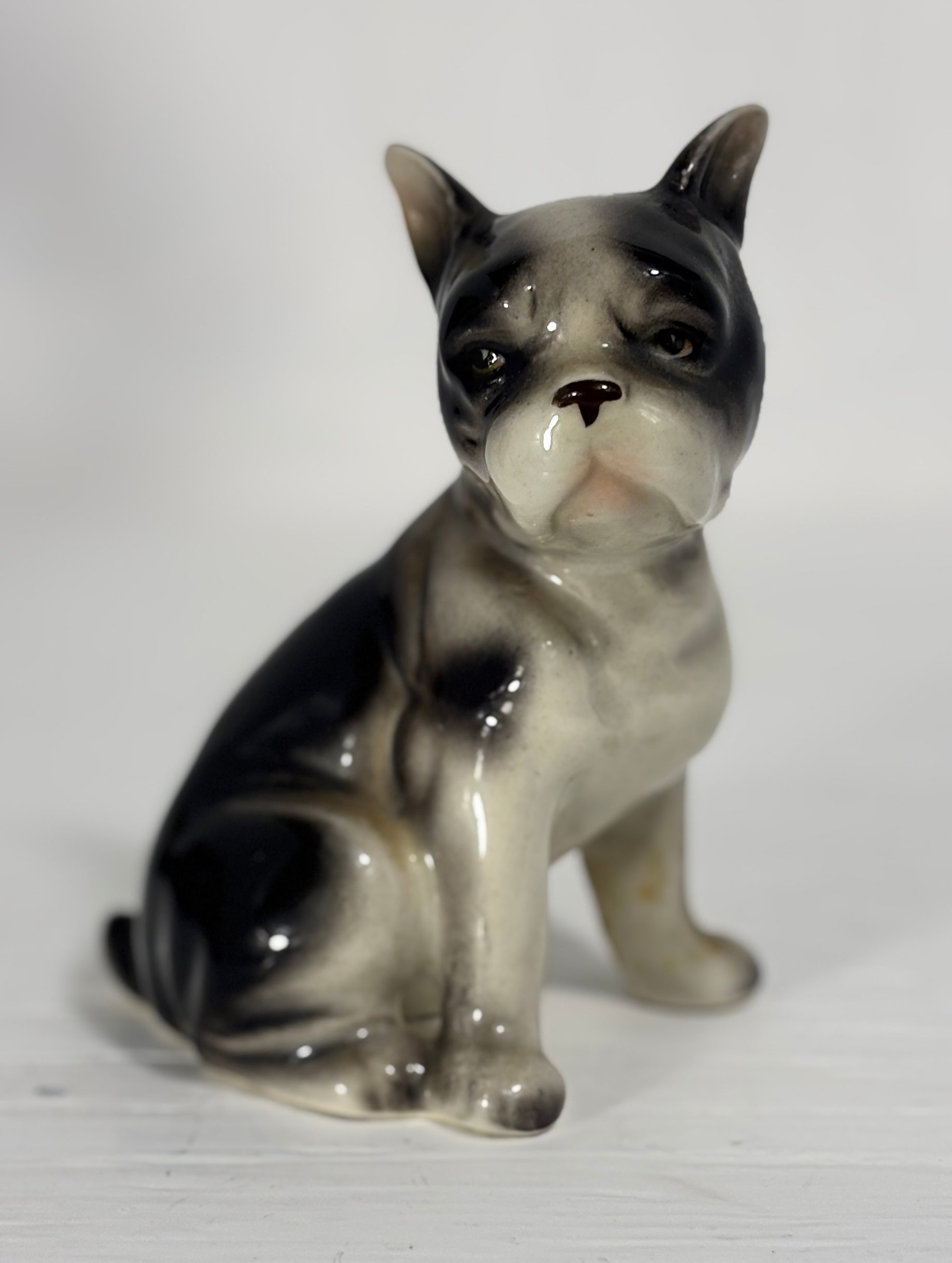 Porcelain figurine of a dog on a white background