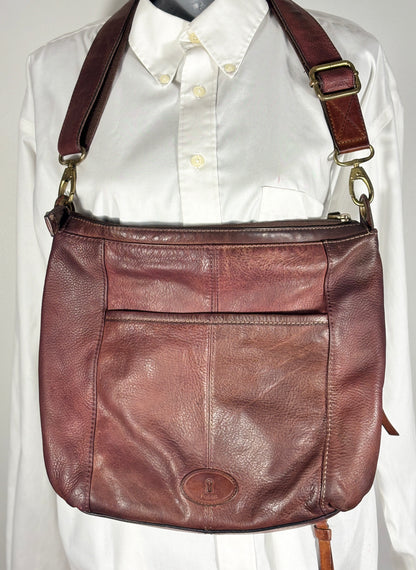 Brown leather shoulder bag on a white shirt