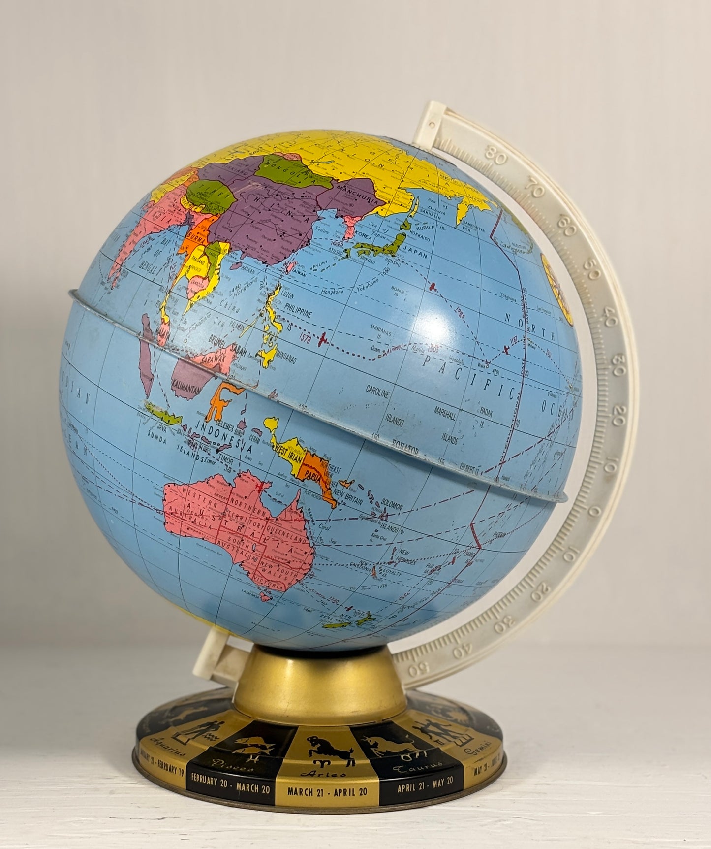 World globe on a stand with a beige background