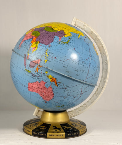 World globe on a stand with a beige background