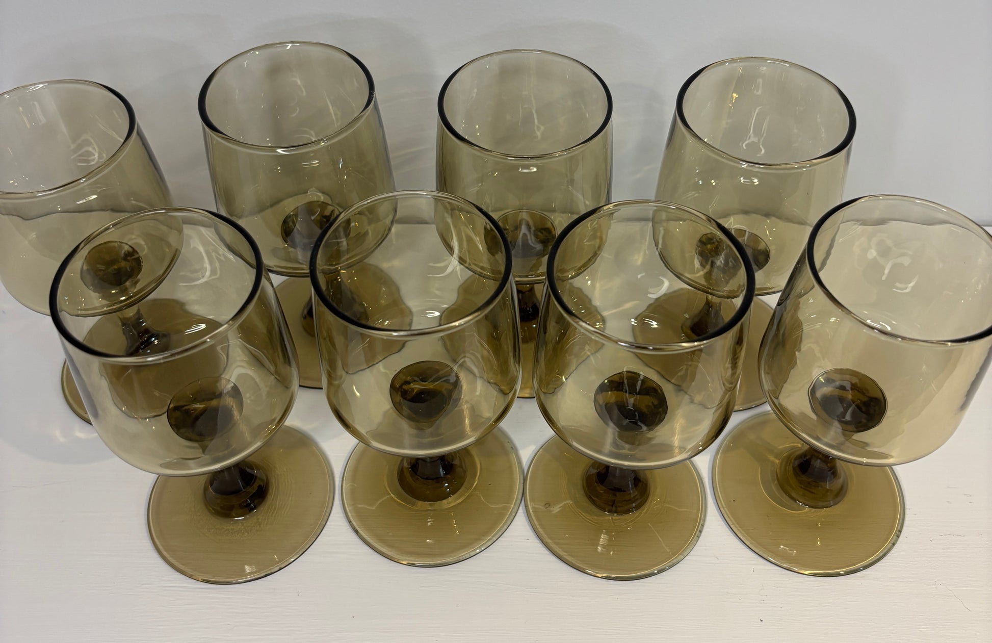 Set of smoked glass wine glasses on a white background