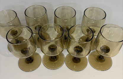 Set of smoked glass wine glasses on a white background