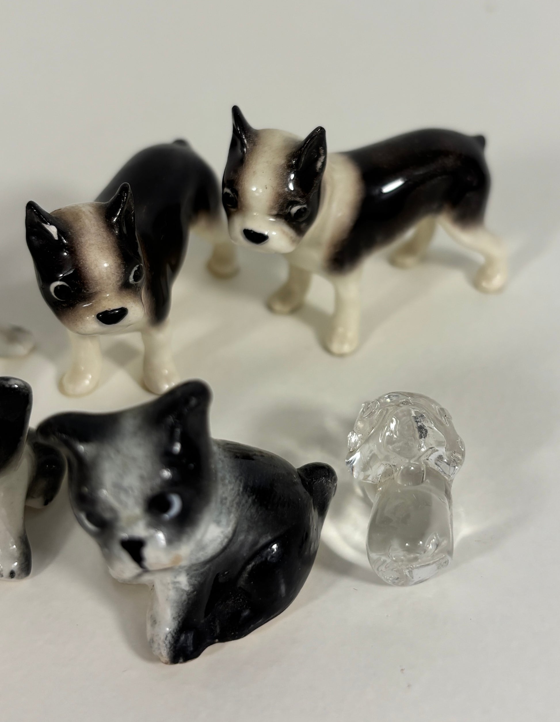 Set of small ceramic dog figurines on a white background