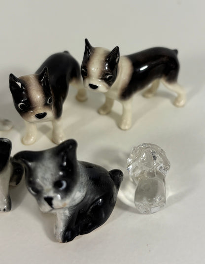 Set of small ceramic dog figurines on a white background