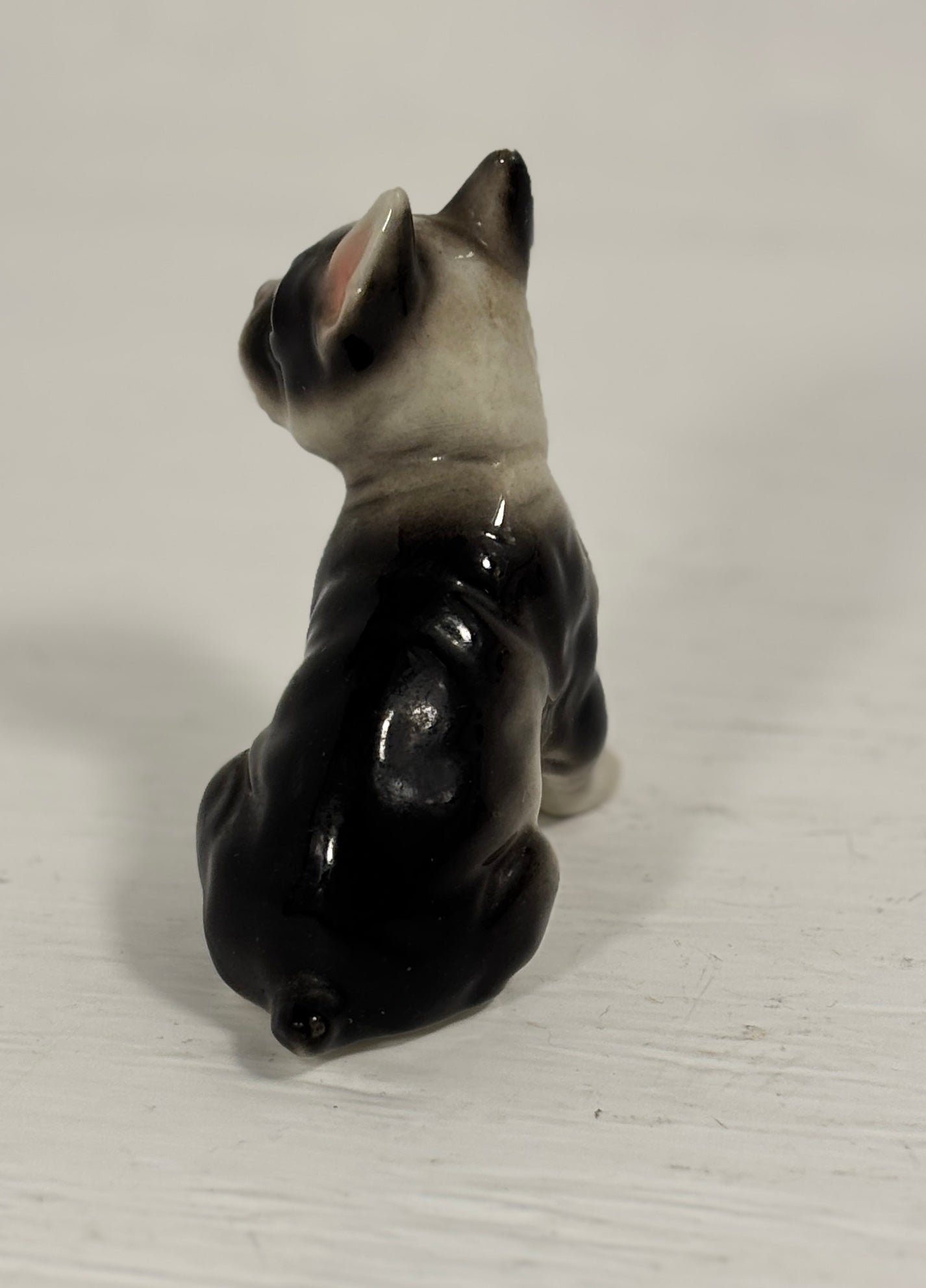 Small ceramic dog figurine on a white background