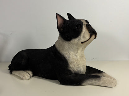 Black and white dog figurine on a plain background