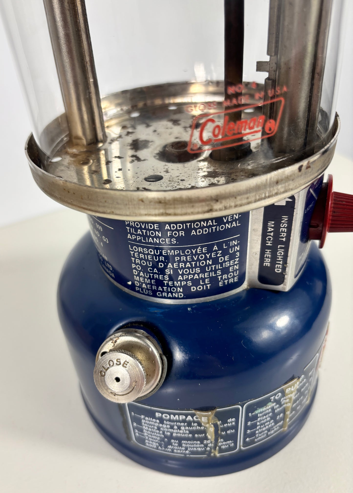 Close-up of a blue camping lantern with visible branding on a white background