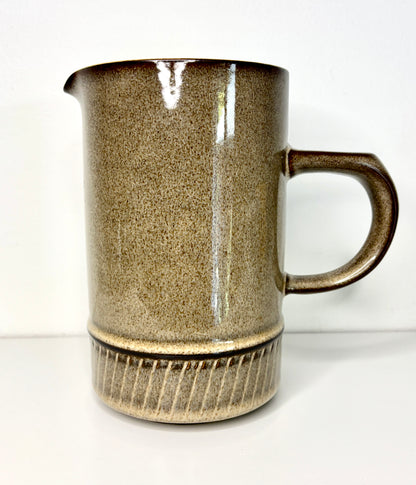 Stoneware mug with textured surface and handle on a white background