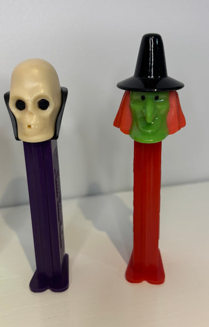 Two Halloween-themed PEZ dispensers on a white background