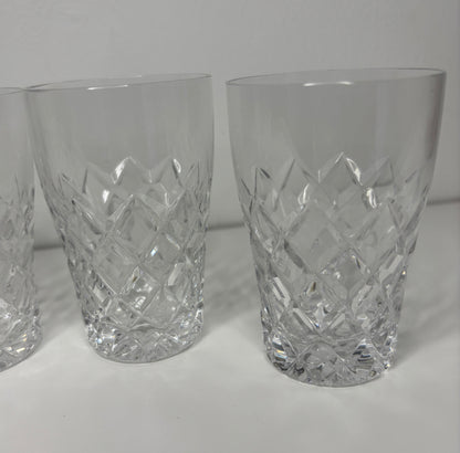 Set of three crystal glasses with diamond pattern on a white background