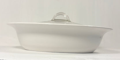 White ceramic dish with a lid on a white background