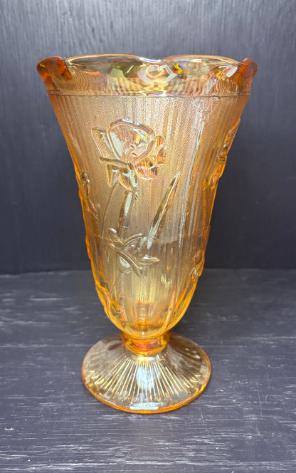 Amber glass vase with floral design on a dark background