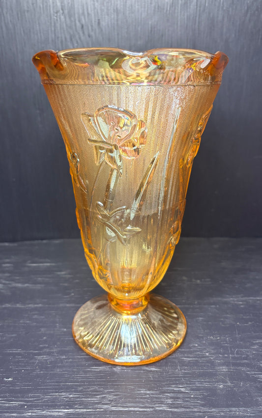 Amber glass vase with floral design on a dark background