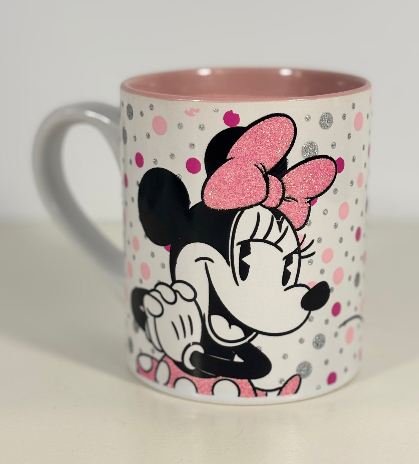 Minnie Mouse mug with pink interior on a light gray background