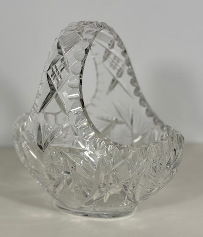 Clear glass basket with cut patterns on a white background