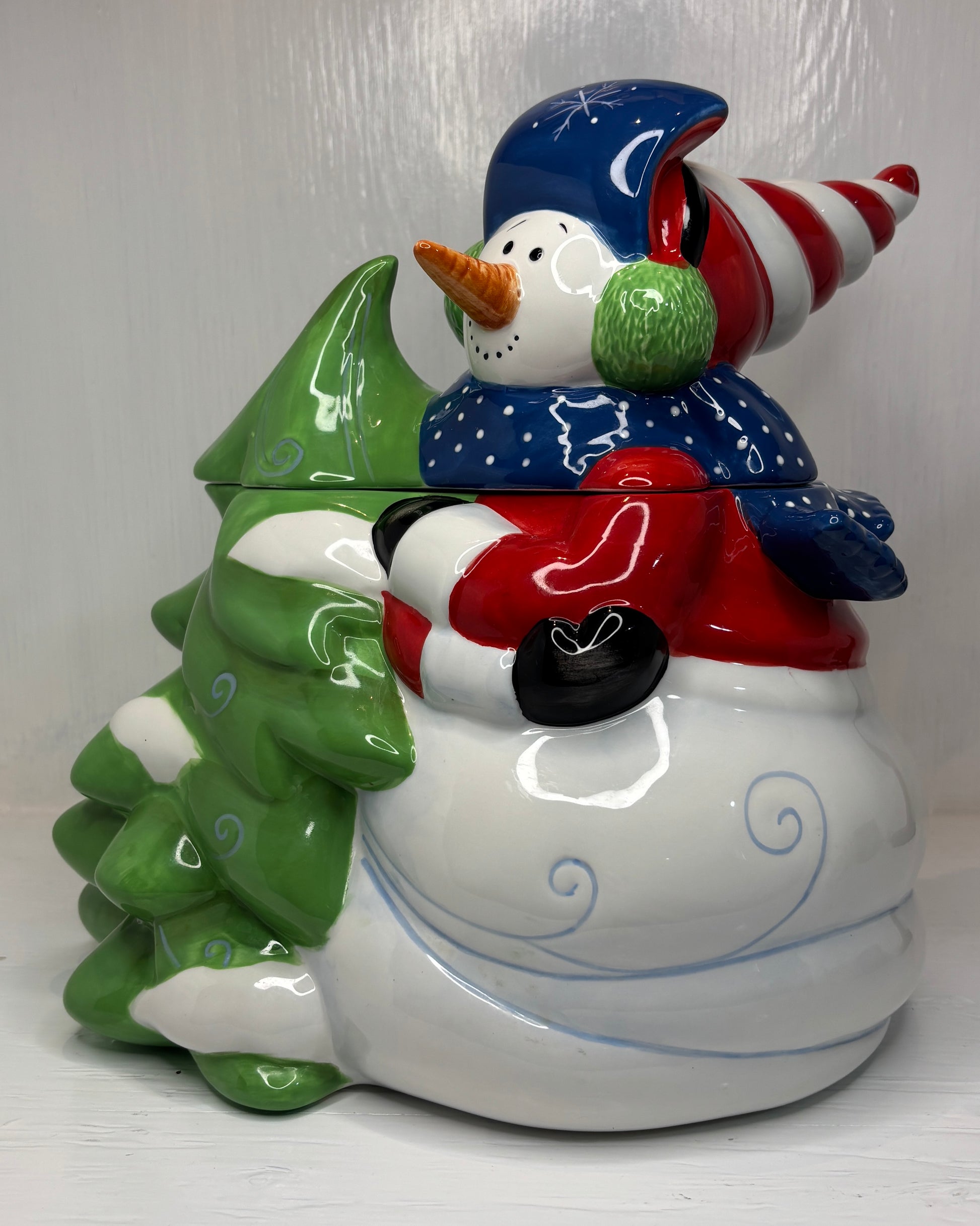 Christmas-themed cookie jar with snowman design on a white background