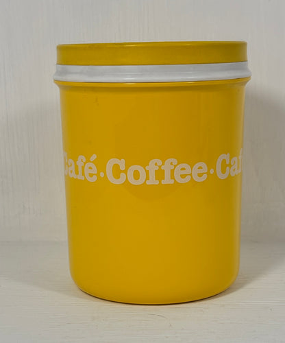 Yellow coffee canister with white text on a light background