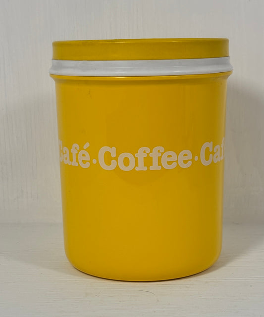 Yellow coffee canister with white text on a light background
