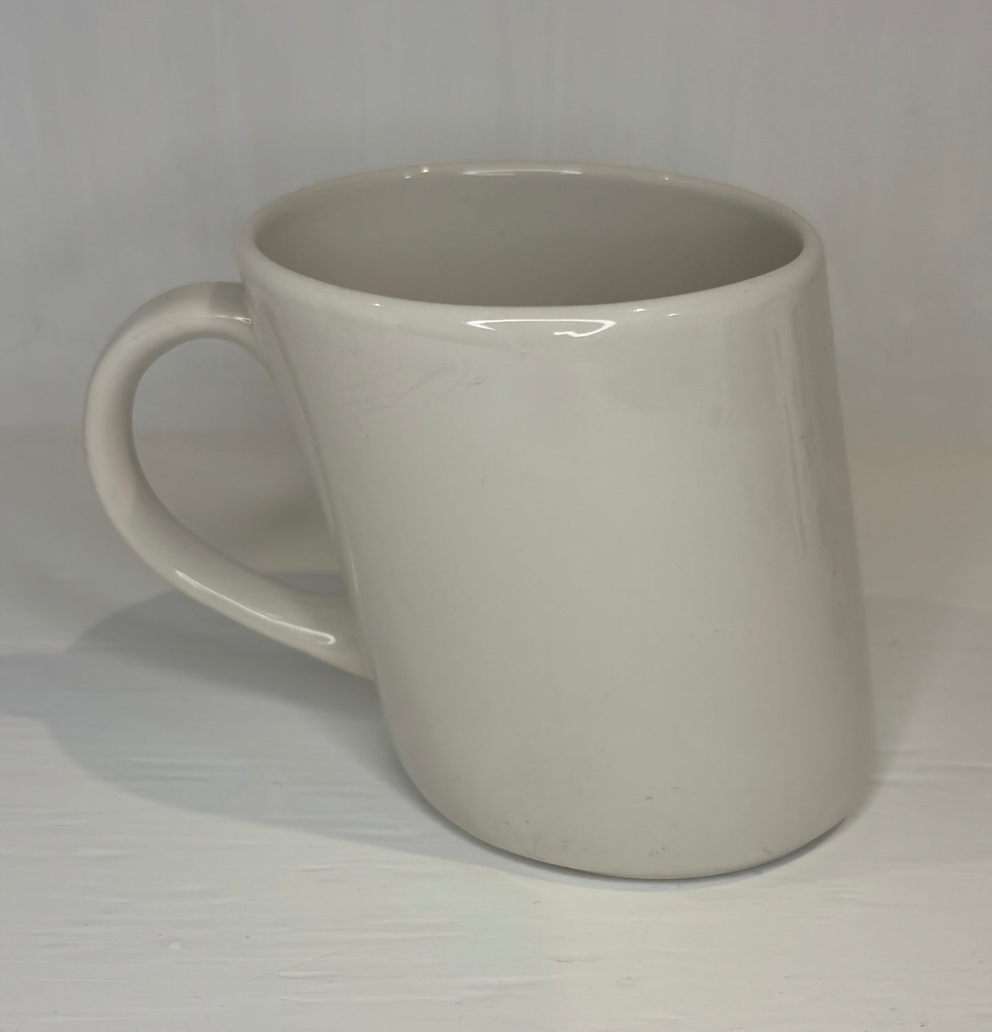 White ceramic mug on a white background