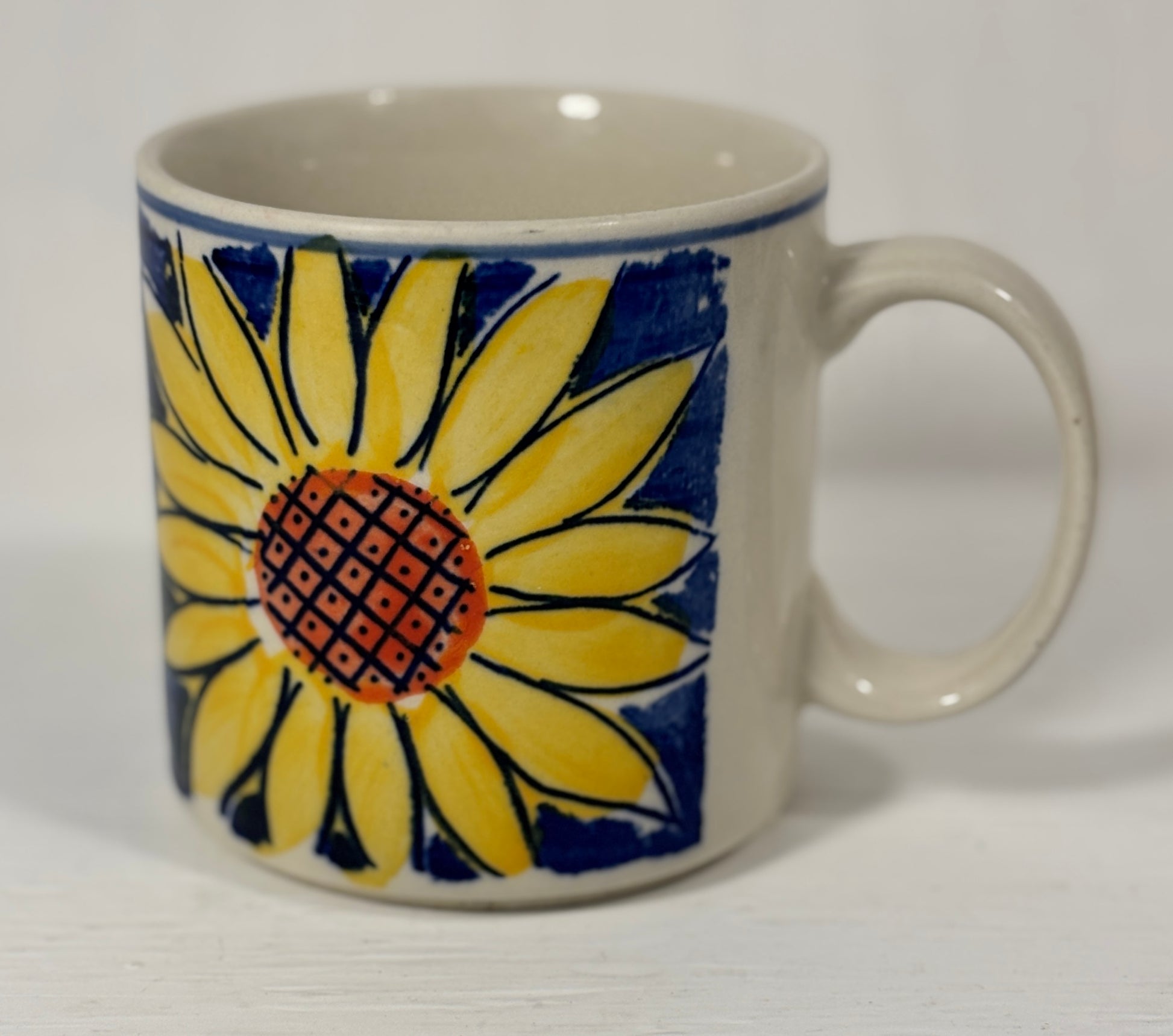 Ceramic mug with a sunflower design on a white background