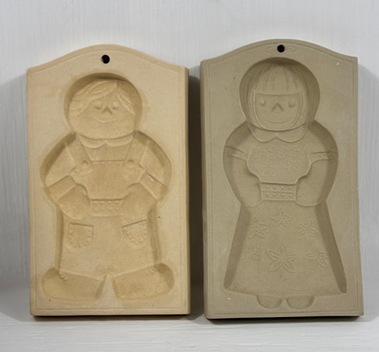 Two mold casts of a boy and a girl on a white background