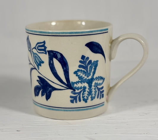 White mug with blue floral patterns on a white background