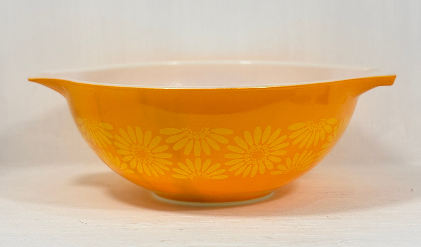 Yellow bowl with floral pattern on a white background
