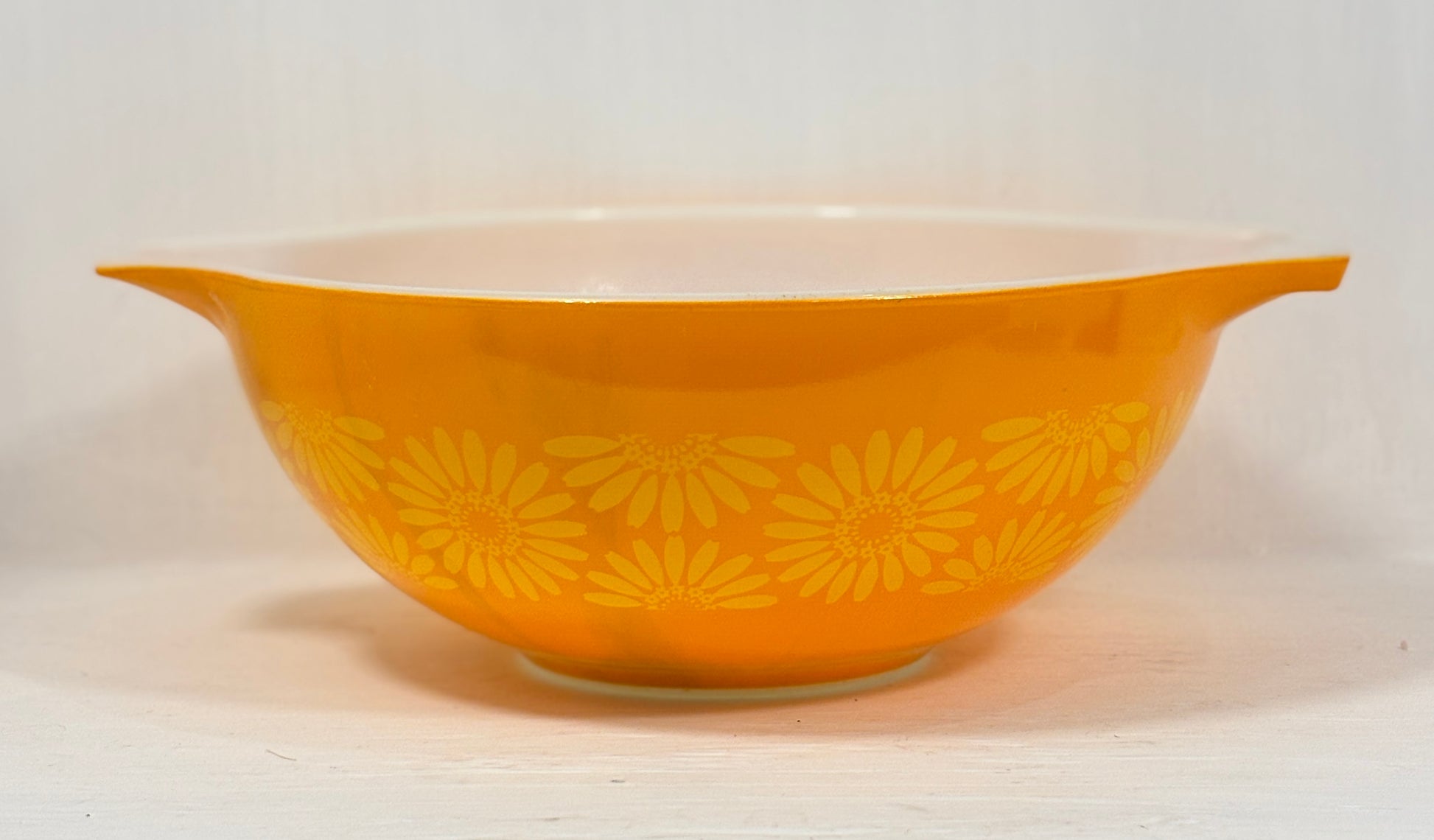 Yellow bowl with floral pattern on a white background
