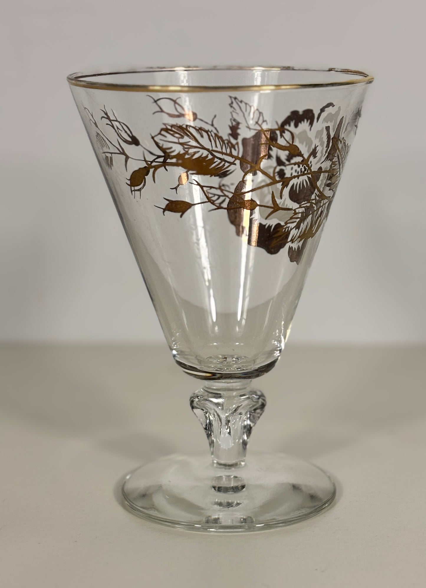 Clear glass with gold floral design on a white background