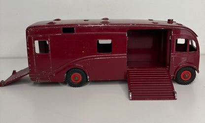 Maroon toy bus with open doors on a white background