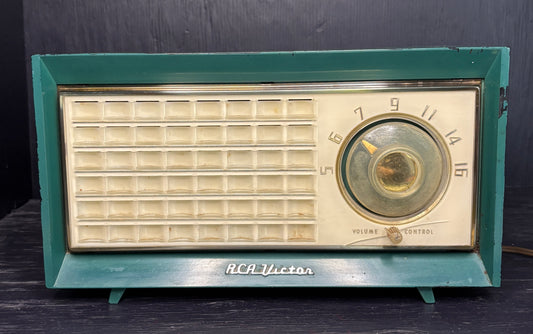 Vintage RCA Victor radio with teal frame on a dark background