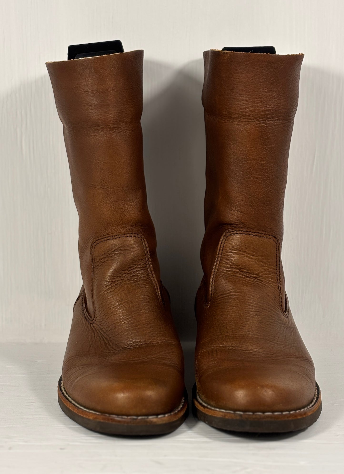 Pair of brown leather boots on a white background