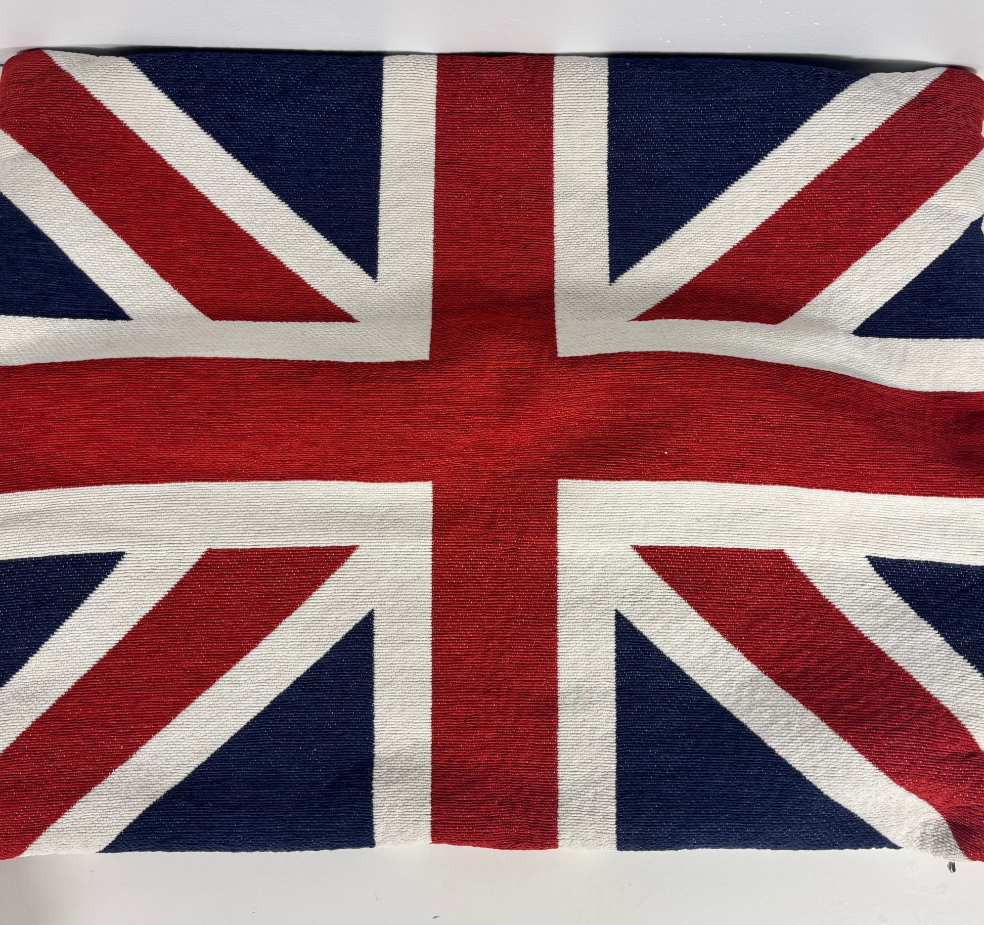 A square woven textile featuring the Union Jack flag pattern, photographed flat against a plain white background.