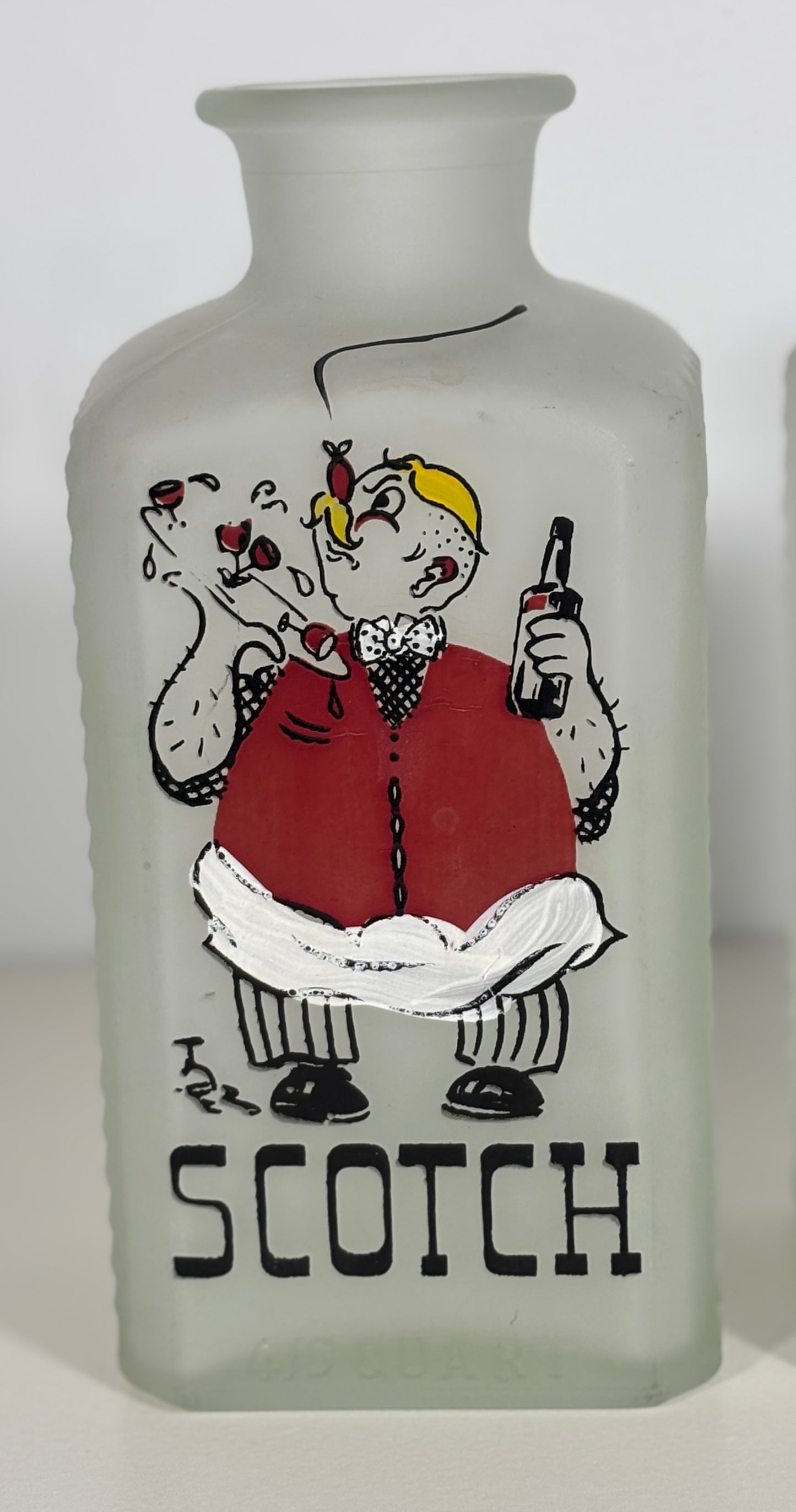 Frosted glass bottle with a cartoon character and 'Scotch' text on a white background