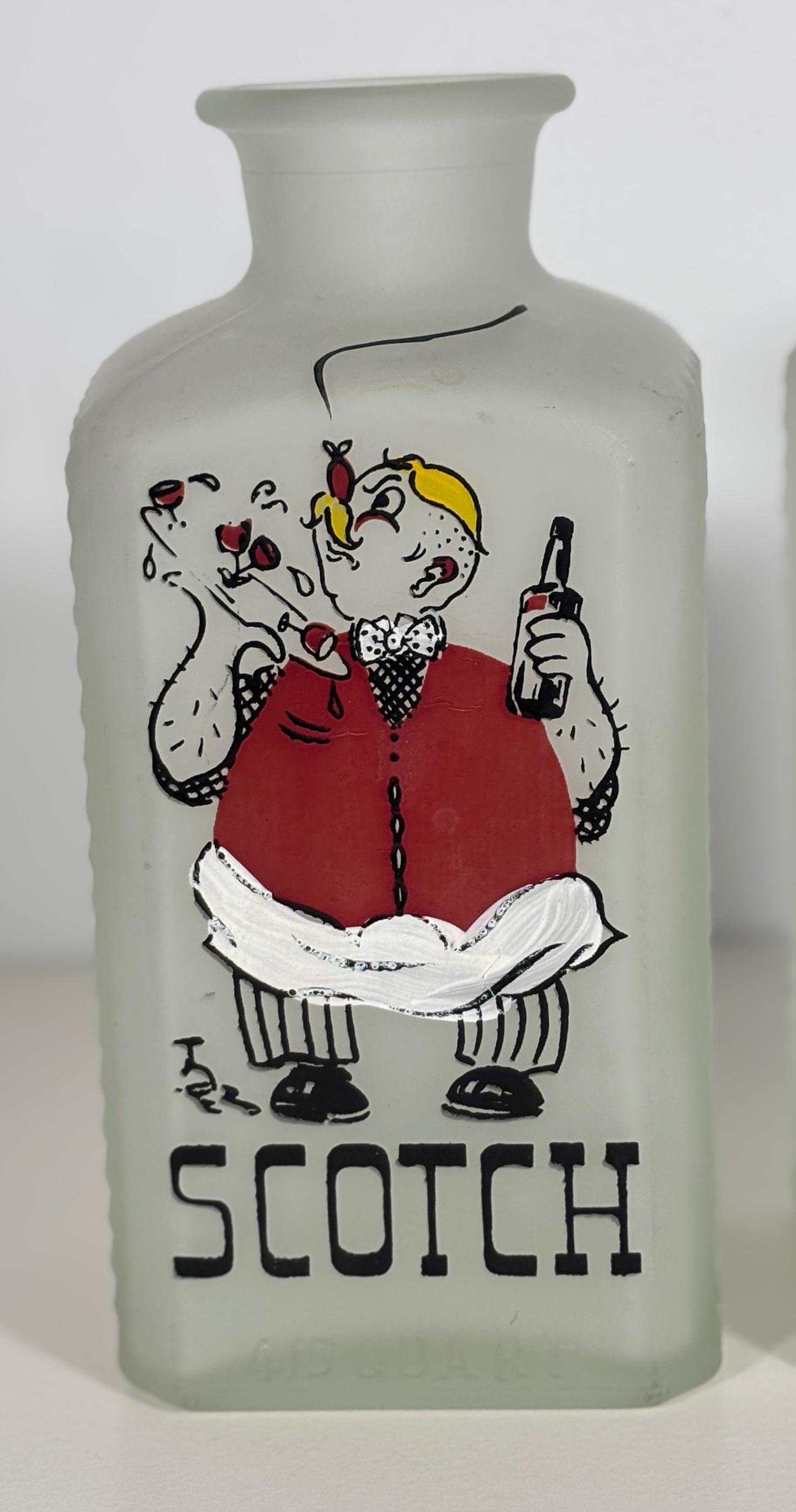 Frosted glass bottle with a cartoon character and 'Scotch' text on a white background