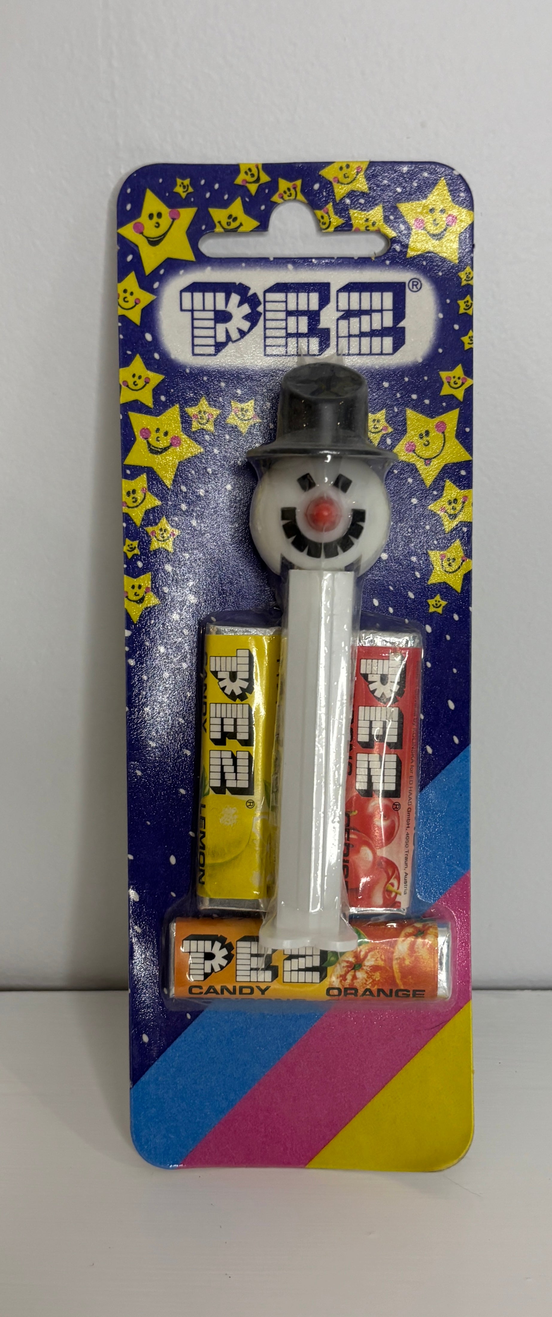 PEZ candy dispenser with snowman design on a colorful packaging background