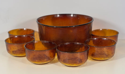 Set of amber glass bowls on a white background