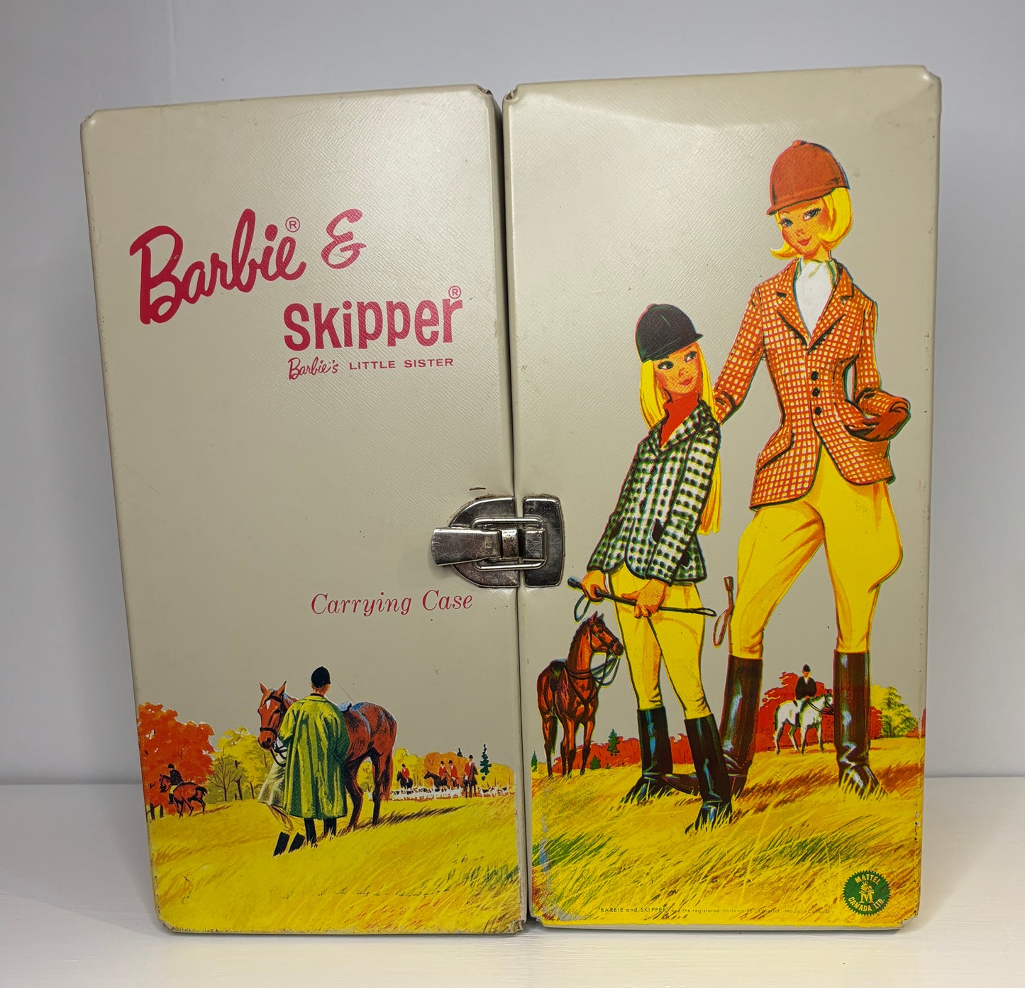 Barbie and Skipper carrying case with illustrations of the dolls and horses on a beige background.