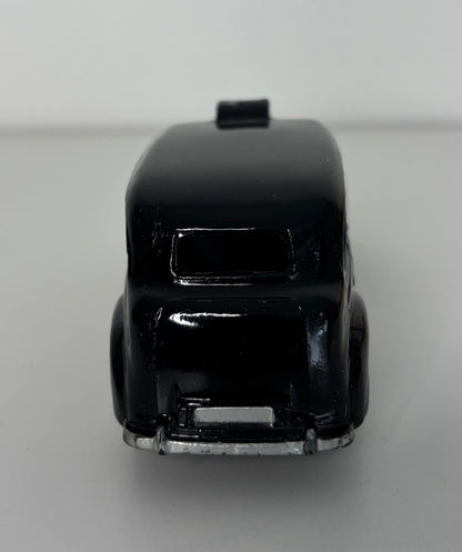Black toy car on a gray background