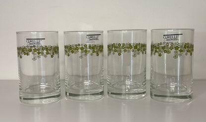 Four Corolle tumblers with green floral design on a white background