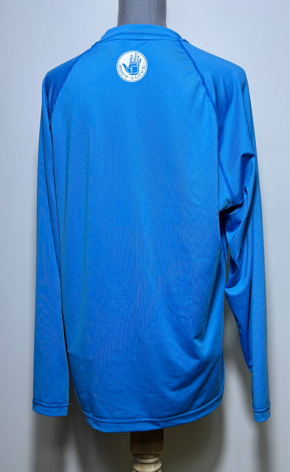 Blue long-sleeve shirt with a logo on the back, displayed on a mannequin against a light gray background.